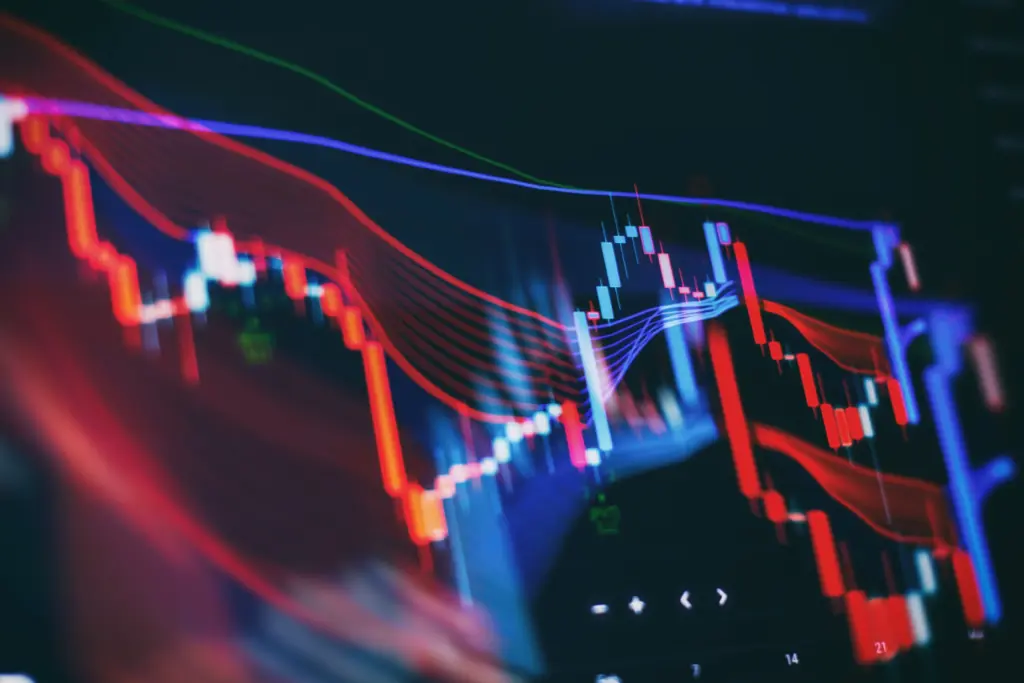 Stock market chart with colorful candlesticks and trend lines on a dark background.