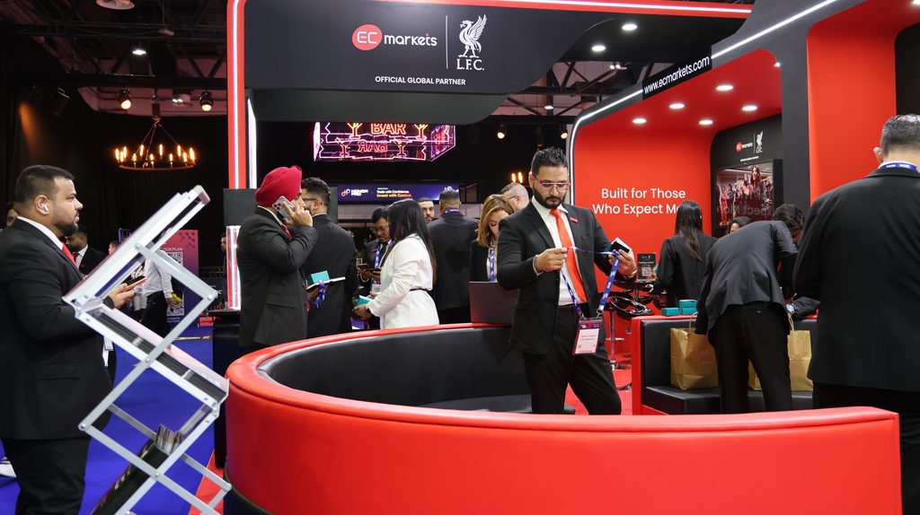 Visitors networking at the EC Markets booth at Forex Expo Dubai