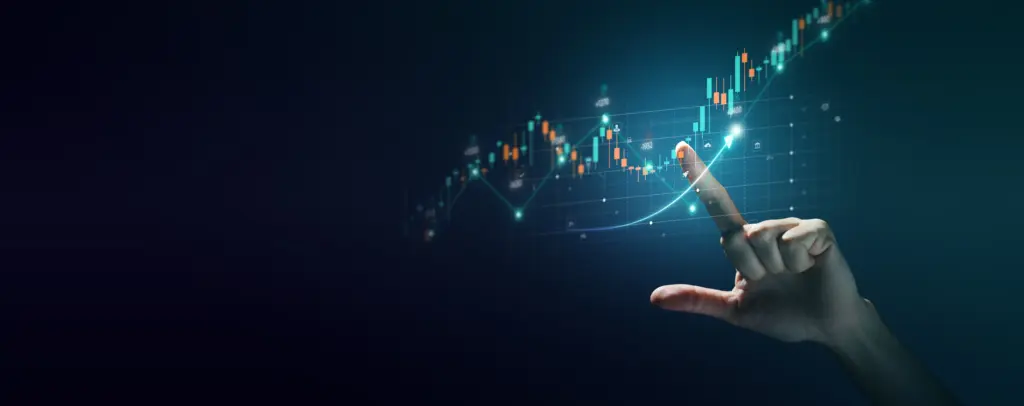 Hand reaching toward a glowing stock chart with candlesticks and an upward-trending line on a dark background.