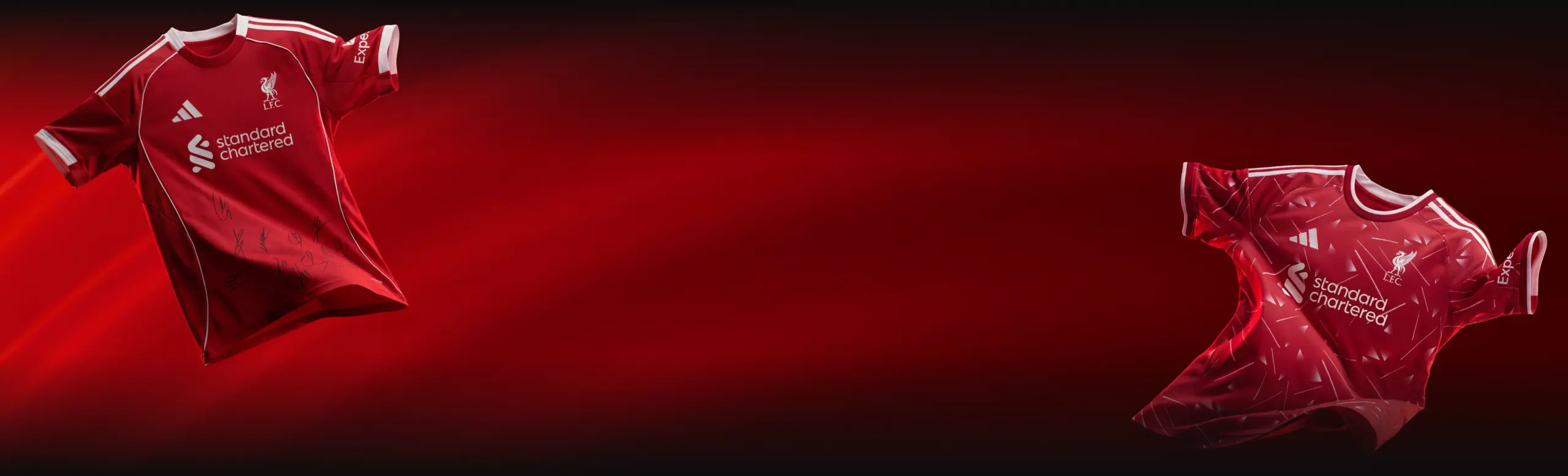 Two red Liverpool FC jerseys float in a dark red gradient backdrop, featuring the Standard Chartered sponsor logo.