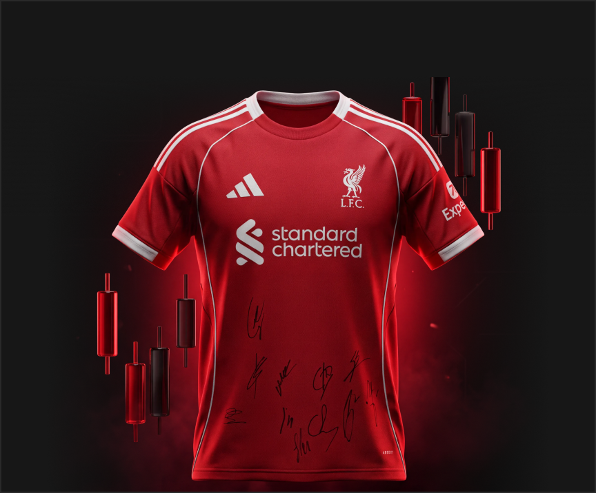 Red Liverpool FC jersey with sponsor logos and autographs, set against a dark background with moody lighting.