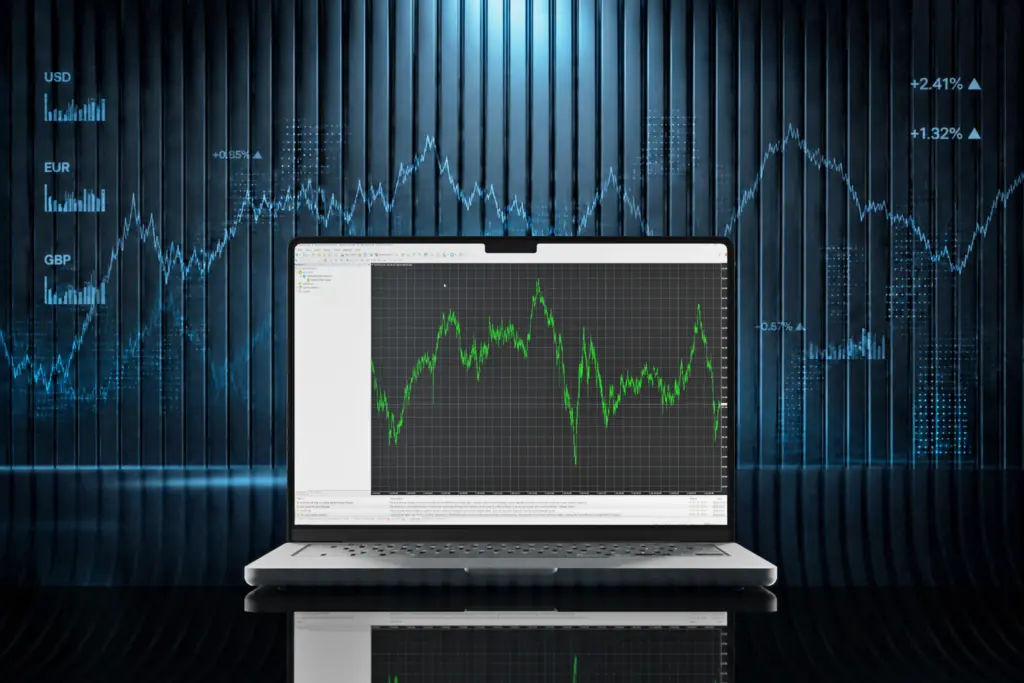 Laptop opened to a charting app showing a green line graph on a dark grid, with a blue financial data background.